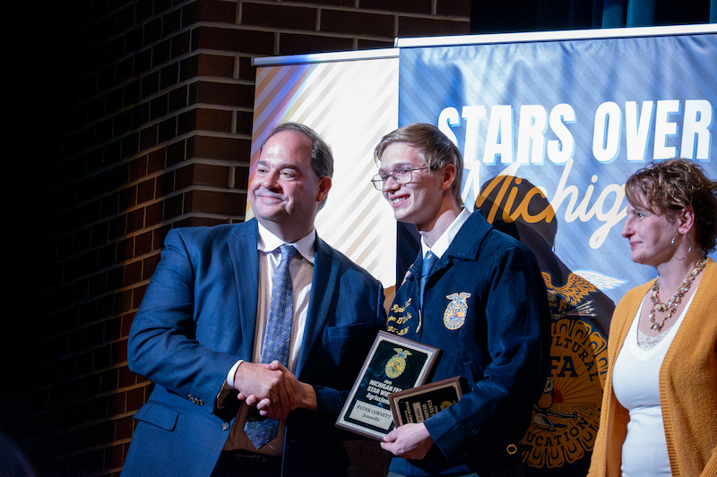 Scott Piggott Michigan FFA Presenting Award to Ryder Cornett
